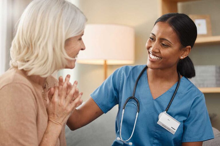 Social worker speaking with an assisted living resident and family member at a care planning table.