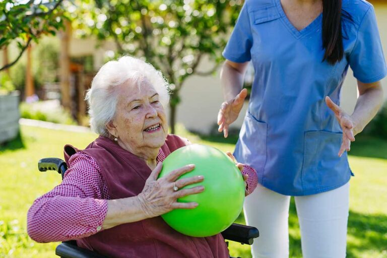 Family members gathered around an elderly resident in a comfortable, home-like assisted living space.